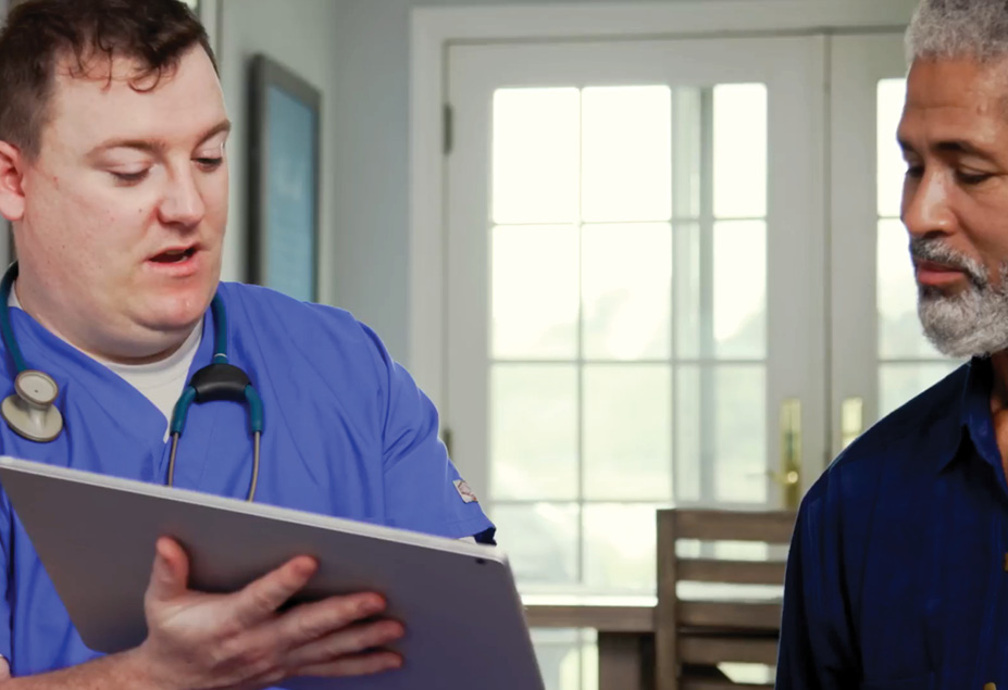 healthcare professional shows patient charts on a tablet