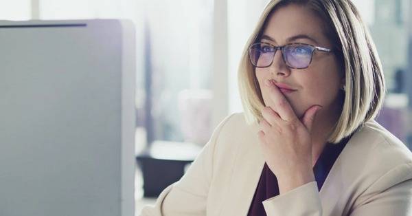 Professional woman staring at laptop screen