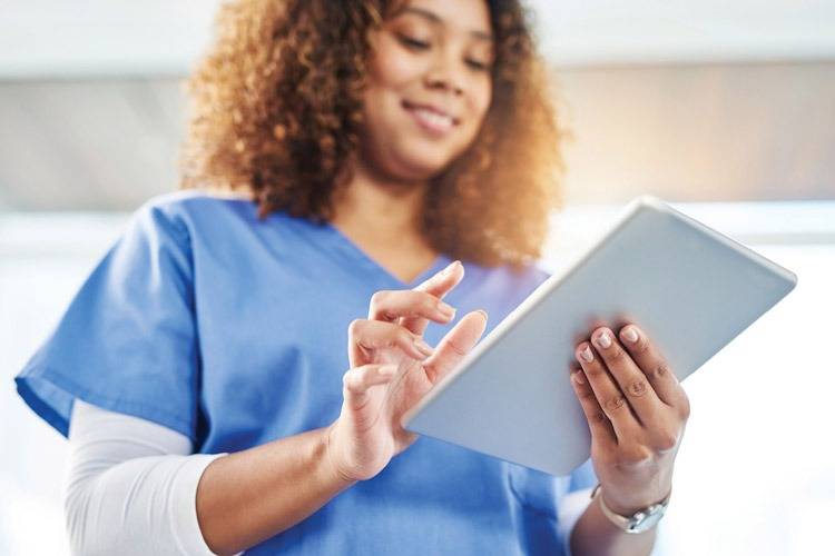 Female nurse using tablet