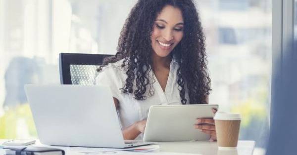 healthcare professional uses a tablet at desk