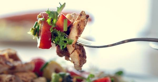 chicken and salad on a fork