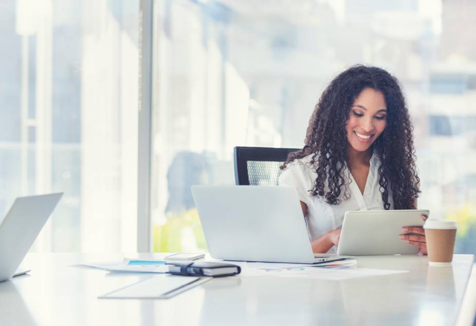 healthcare professional uses tablet and laptop