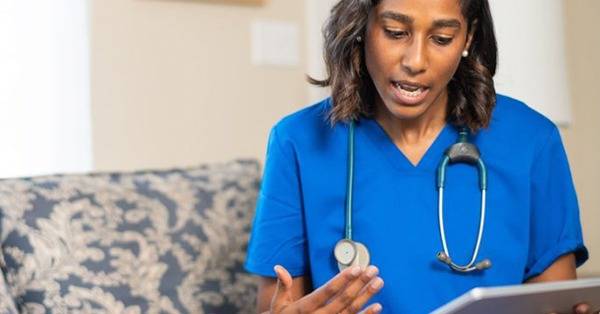 BIPOC healthcare professional provides care via mobile tablet