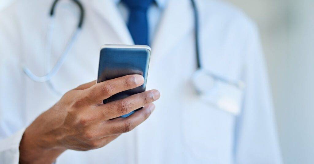 doctor holds smart phone