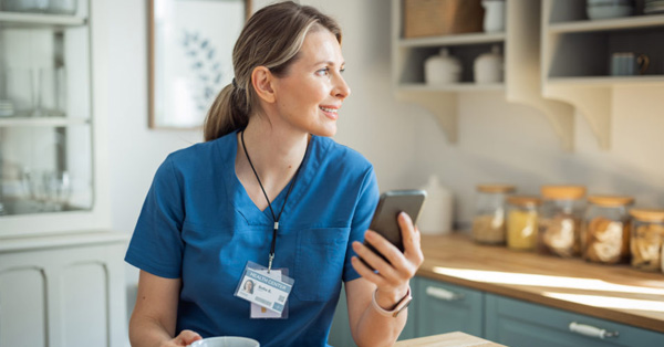 nurse with iphone in kitchen