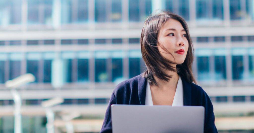 Asian female in front of building