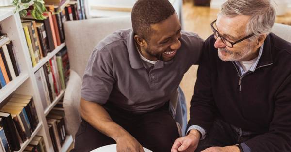 Caregiver laughing with resident