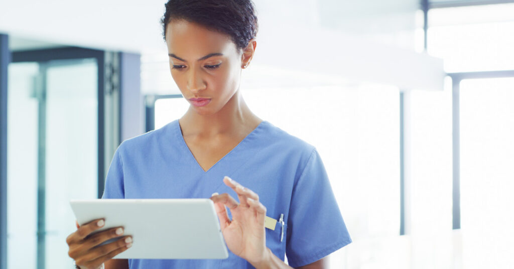 healthcare professional works using a mobile tablet