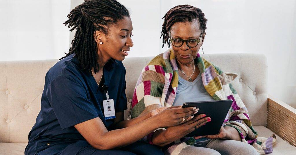 Healthcare professional shows ipad to patient