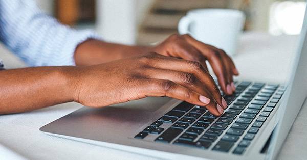hands typing on a laptop