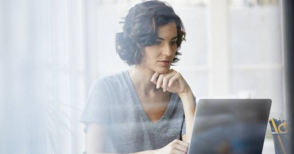 Woman reviewing documents on a computer