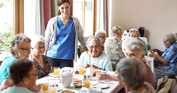 seniors enjoy mealtime with healthcare professor