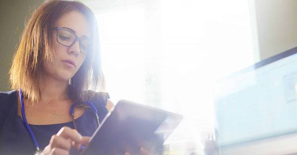 Woman reviewing documents on a computer