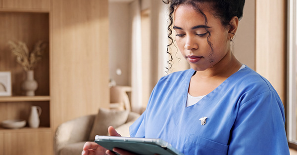 Female Healthcare professional checking data on ipad